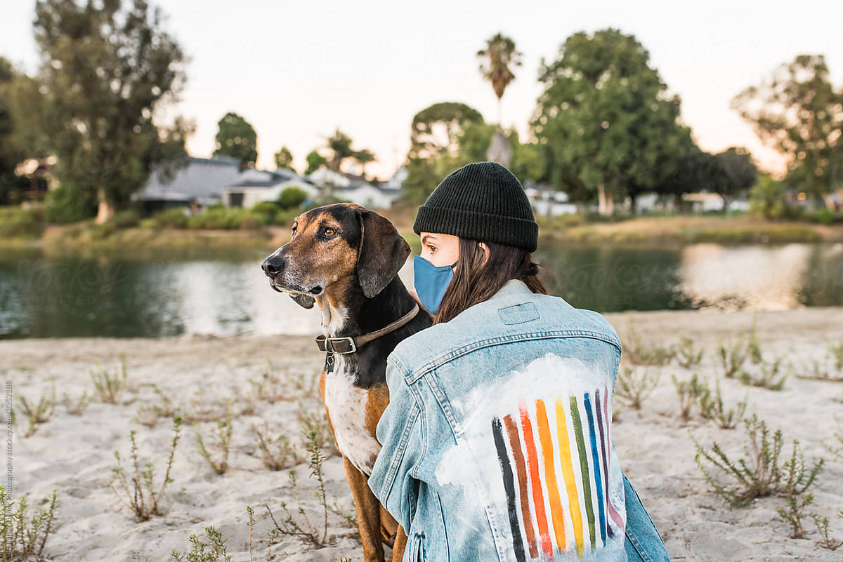 Outdoors in nature with face mask and dog