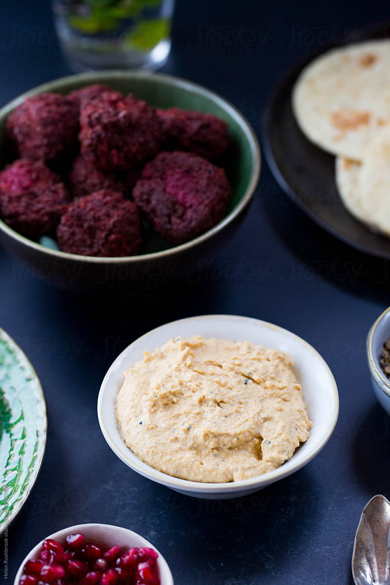 Middle eastern Mezze including aubergine boats, beetroot hummus and beetroot falafel.