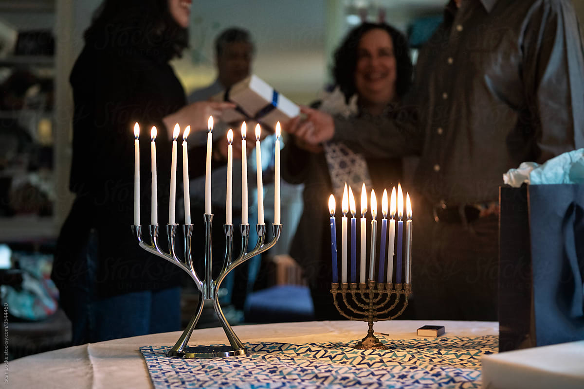 Hanukkah: Family Exchanges Gifts After Lighting Candles