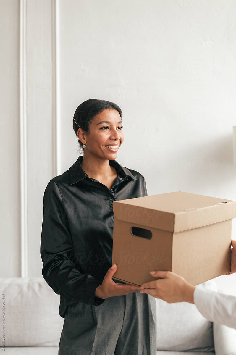 Smiling black woman receiving parcel