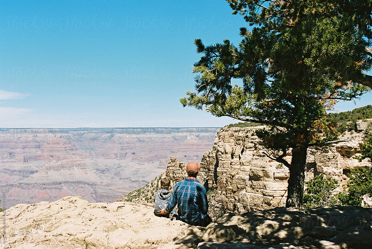 Father and Son Look Out at The Grand Canyon