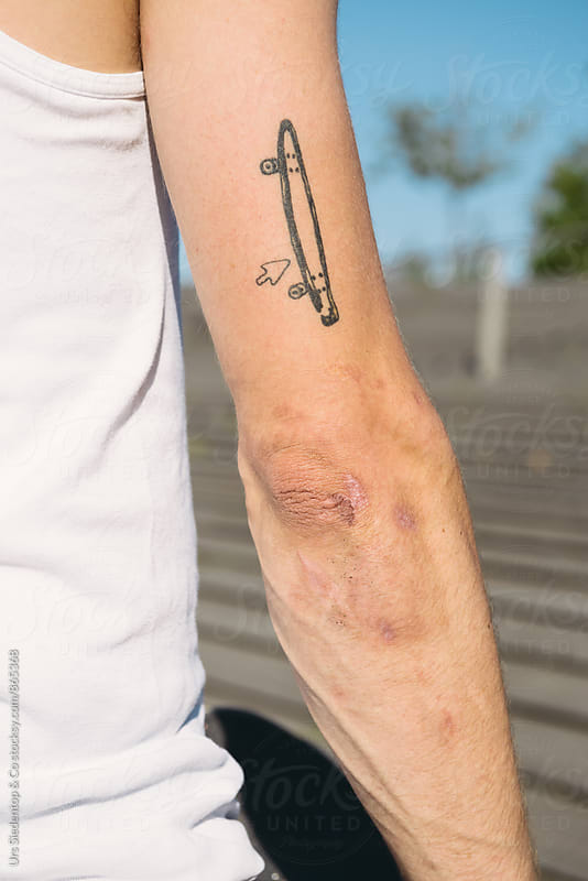 Upper arm with Skateboard Tattoo