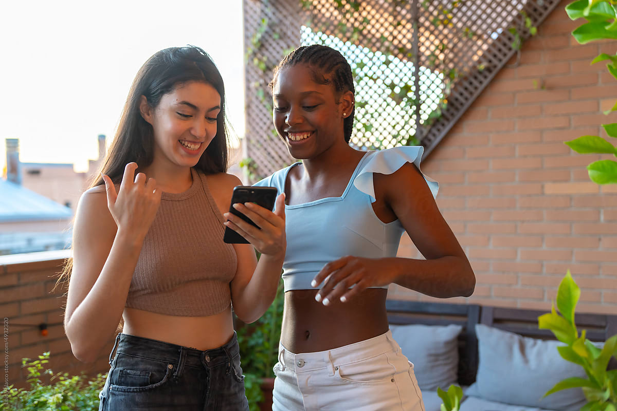 Two Girls Playing In TikTok In Front Of The Phone.