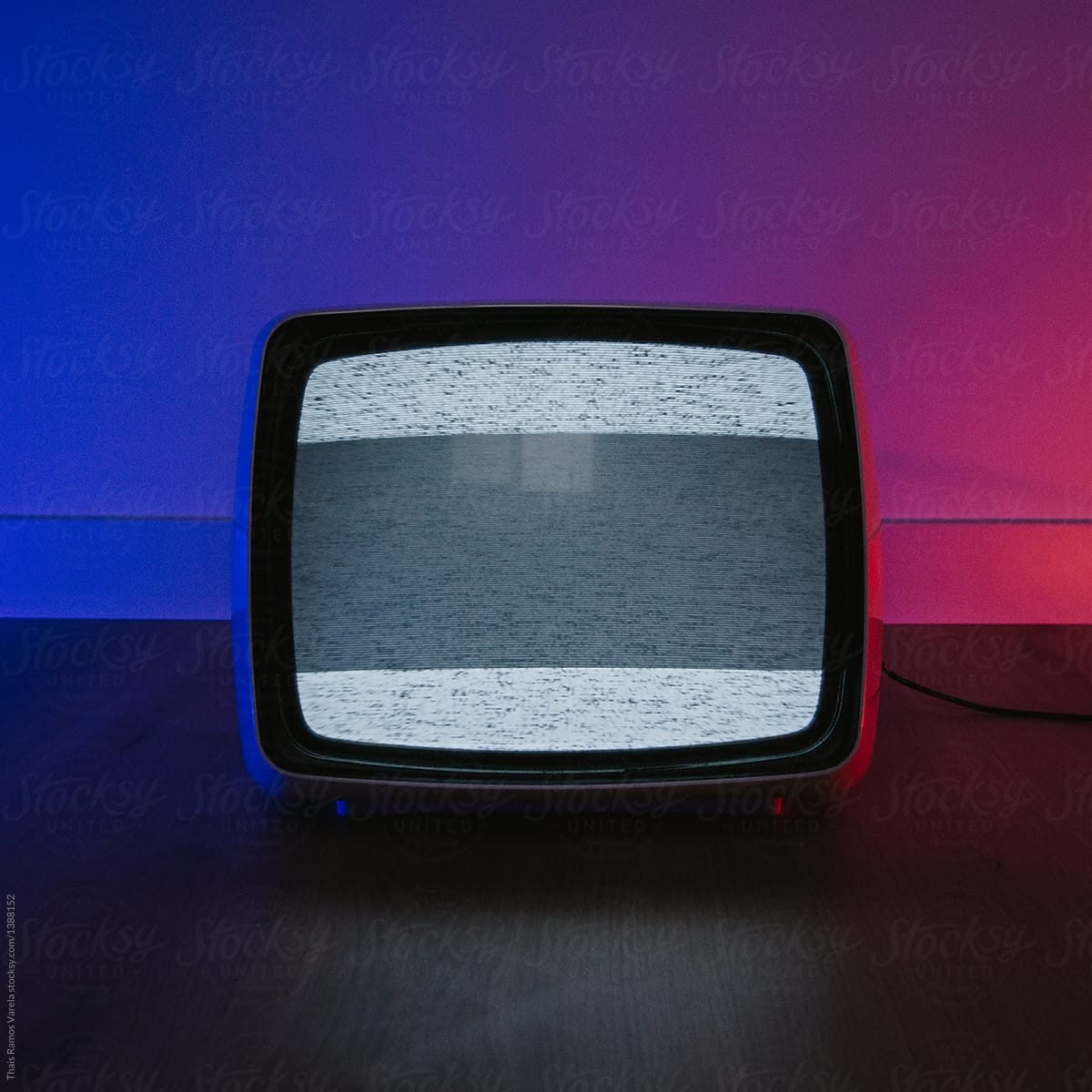 vintage television on a blue/red iluminated room