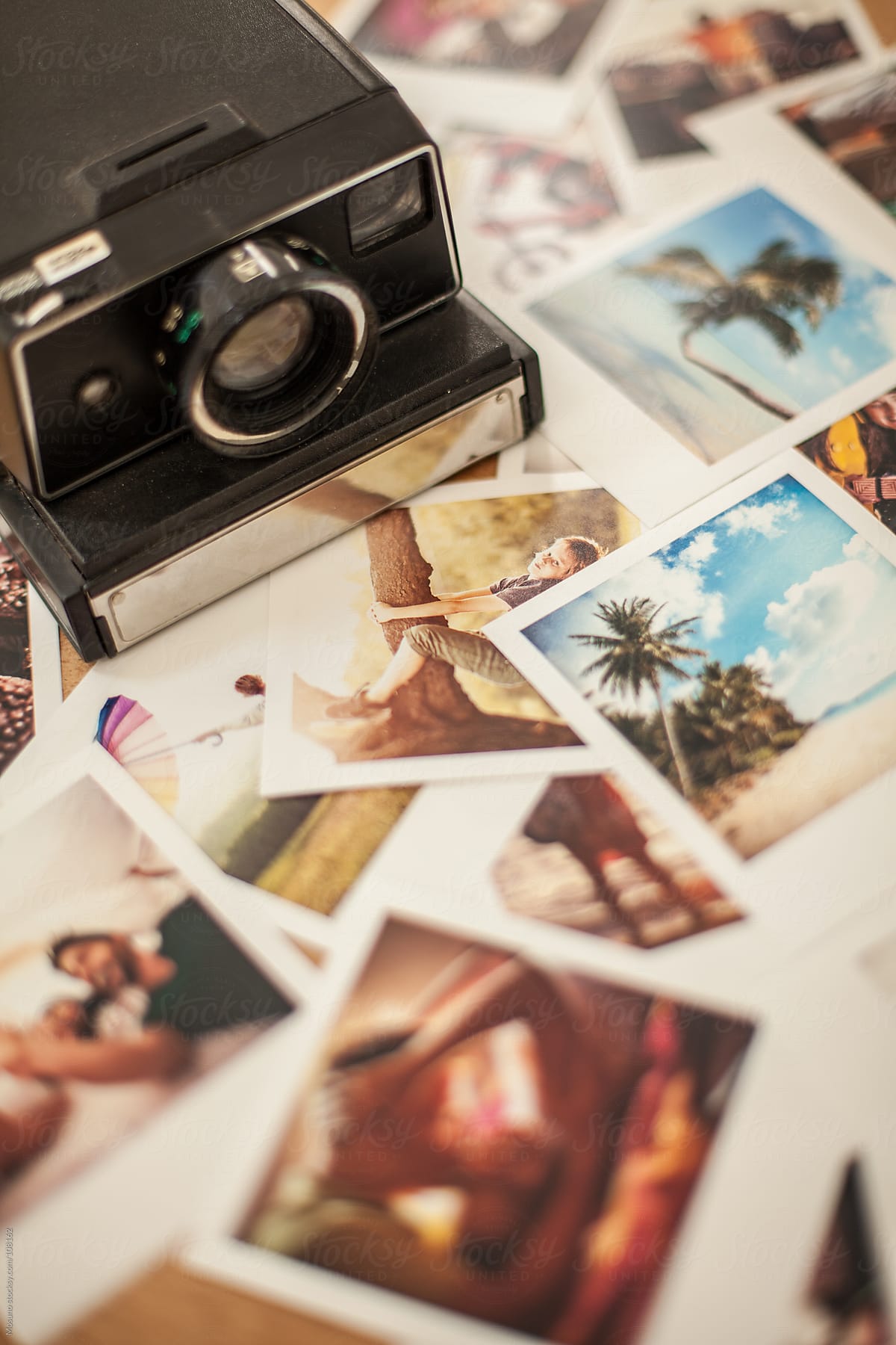 Polaroid Camera and Photos on the Table
