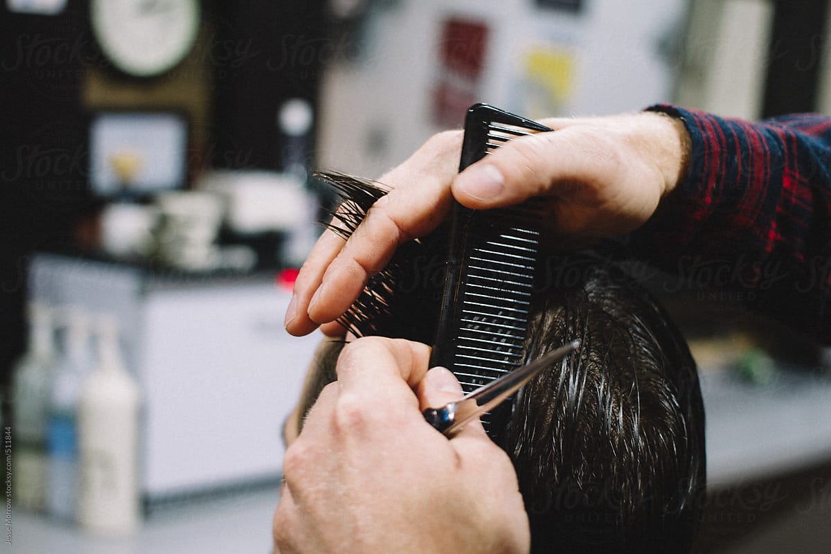 "Barber Cuts Young Male Hair" by Stocksy Contributor "Jesse Morrow