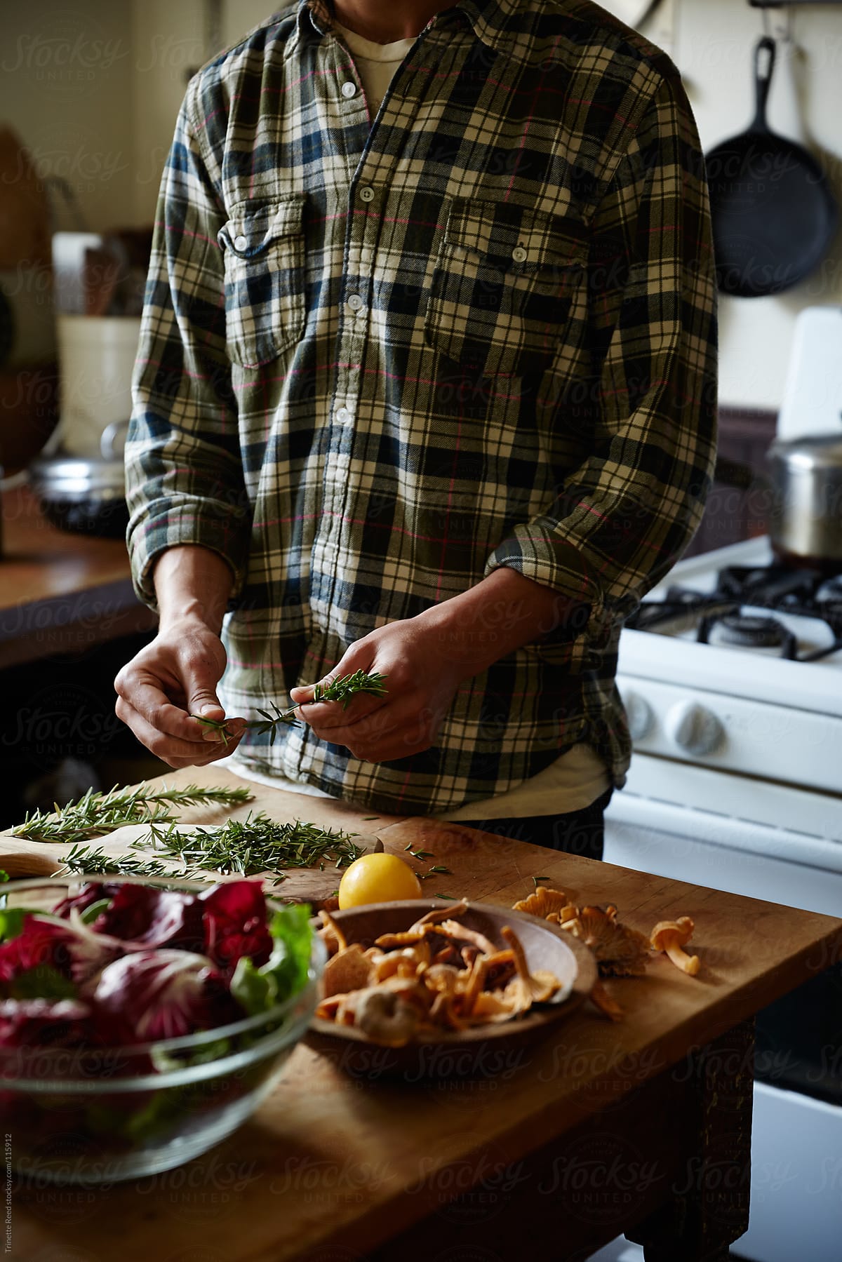 "Man Cooking Food In His Kitchen" by Stocksy Contributor "Trinette Reed