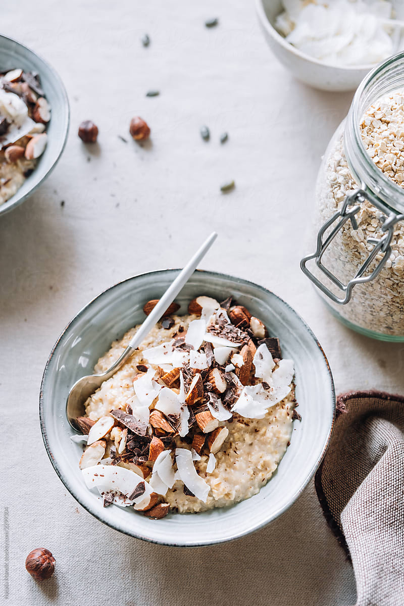 Delicious homemade porridge with nuts, shredded coconut and choc