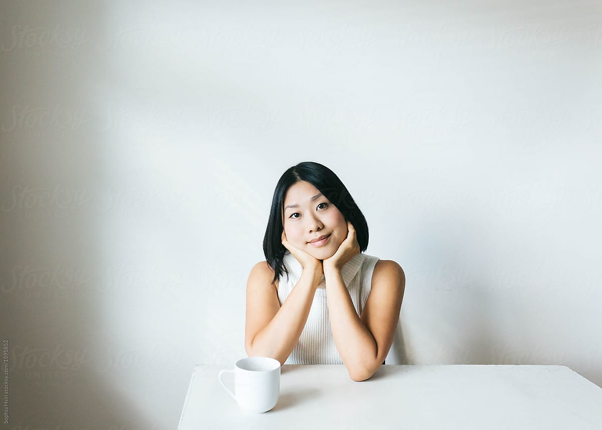 Portrait of young woman in minimalist setting looking at camera