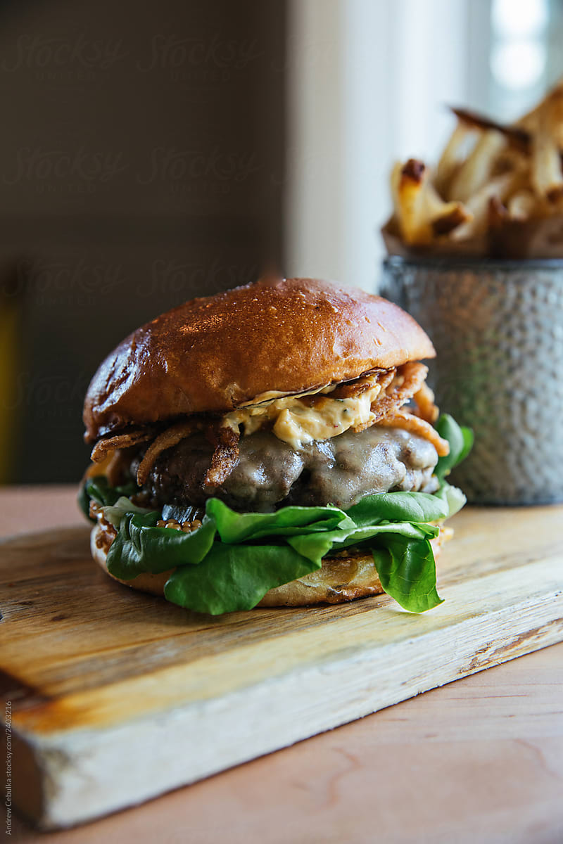 Cheeseburger with Lettuce and Fried Onions and French Fries