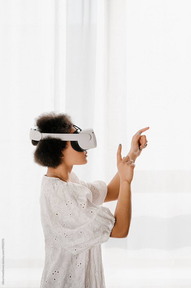 Black female in VR glasses interacting with cyberspace
