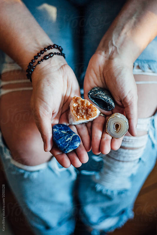 Female hands holding crystals and gemstones