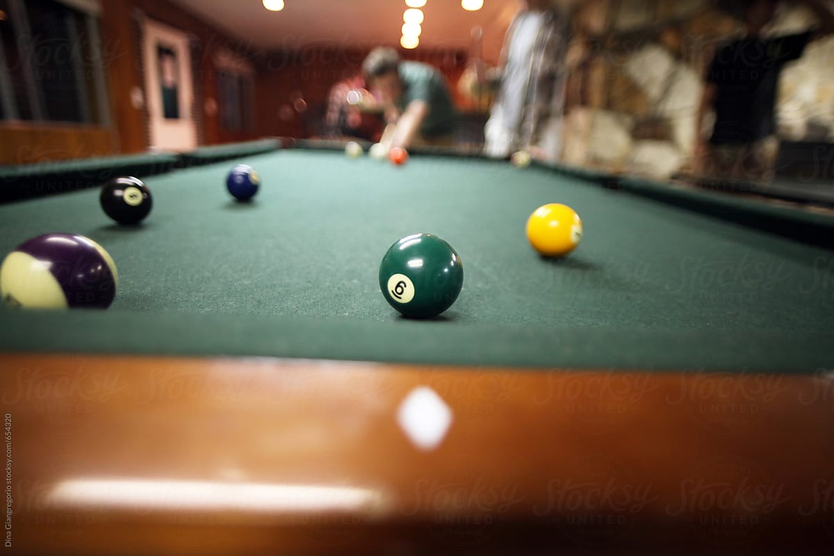 Person Playing the game of pool
