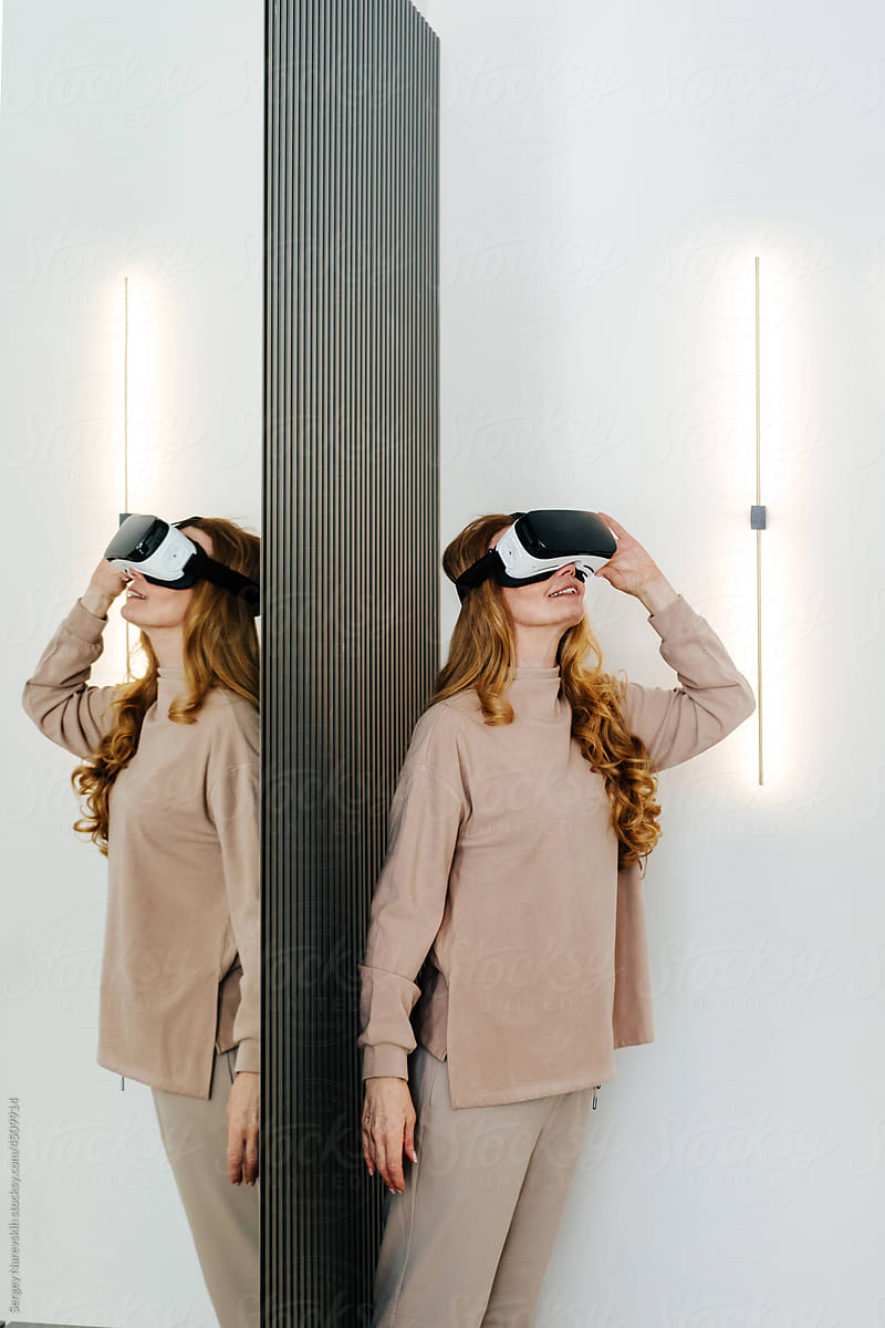 Amazed woman in VR glasses at home