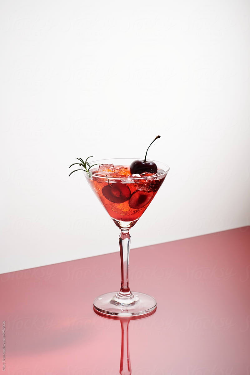a glasses of pink gin or vodka infused with fresh cherry