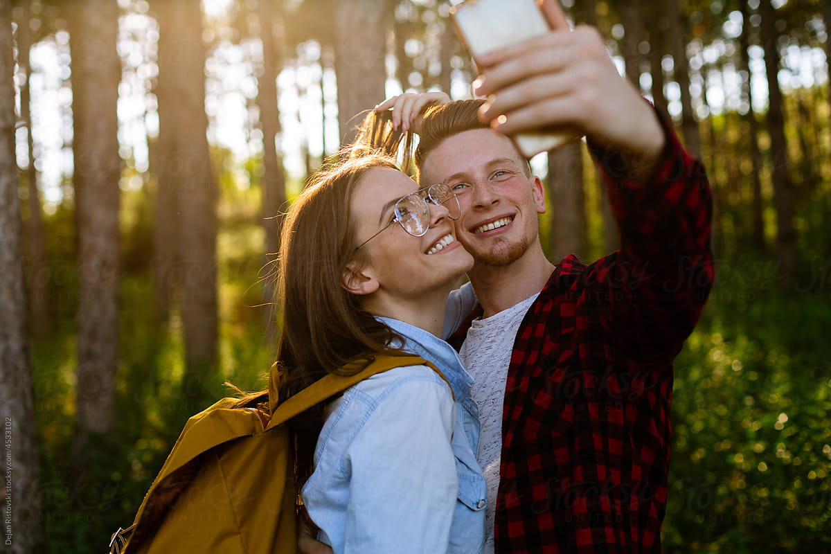 Couple taking selfie in the forest