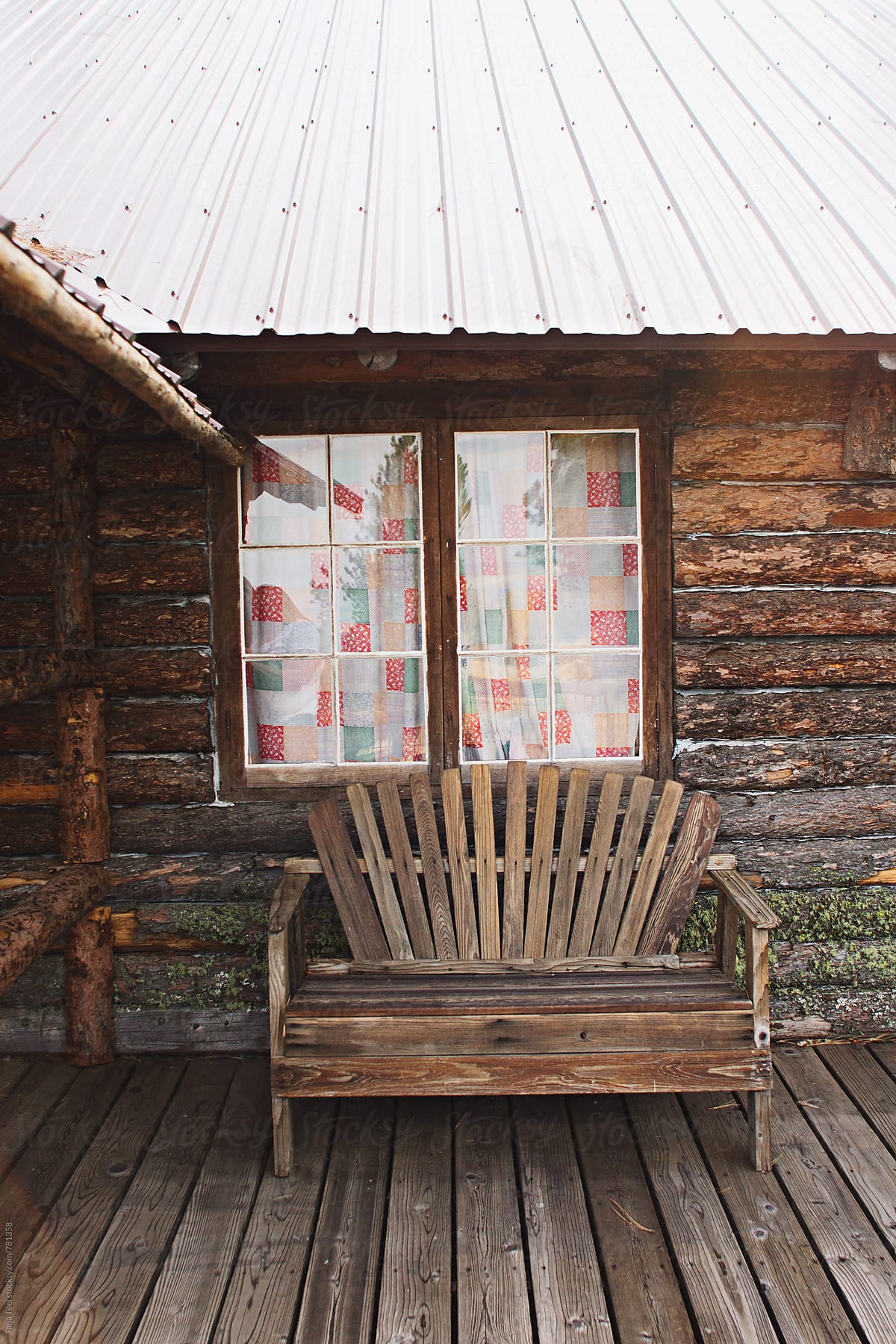 rustic wood bench in front of cabin window