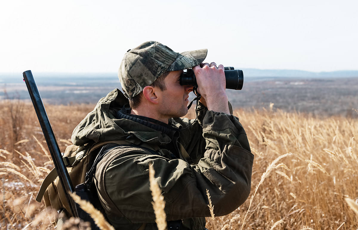Huntsman watching prey through binoculars