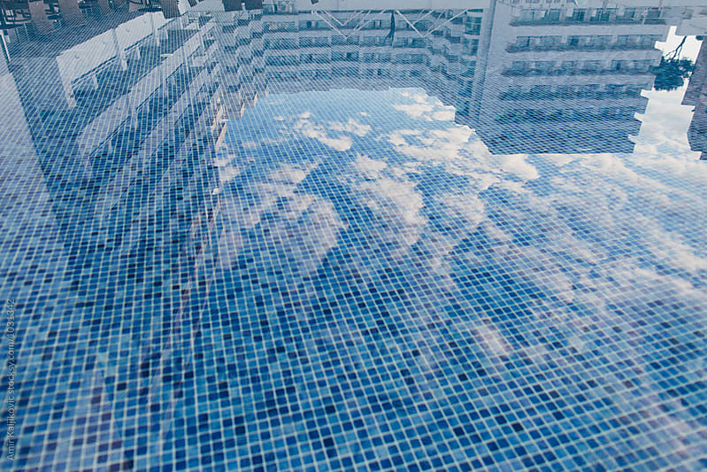 Modern apartments or hotel reflected in a pool