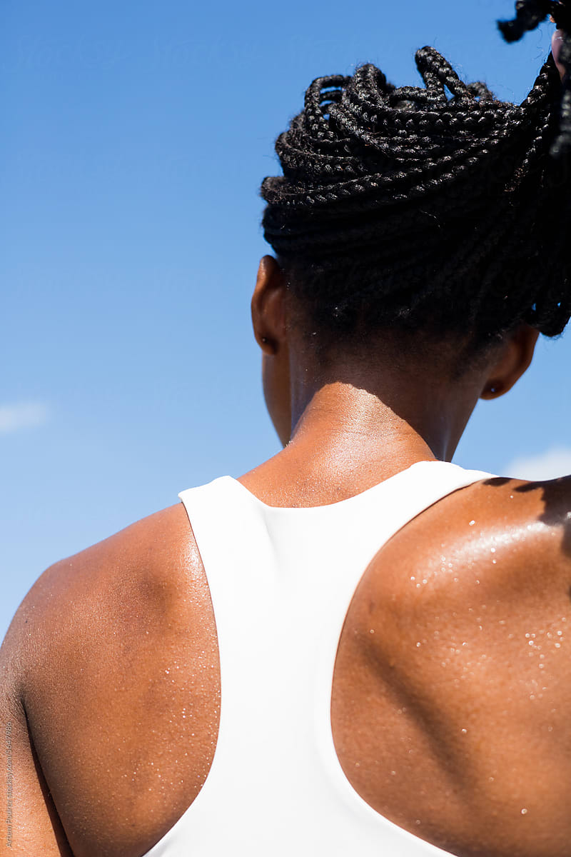 Muscular back of a woman with sweat drops after a sports workout