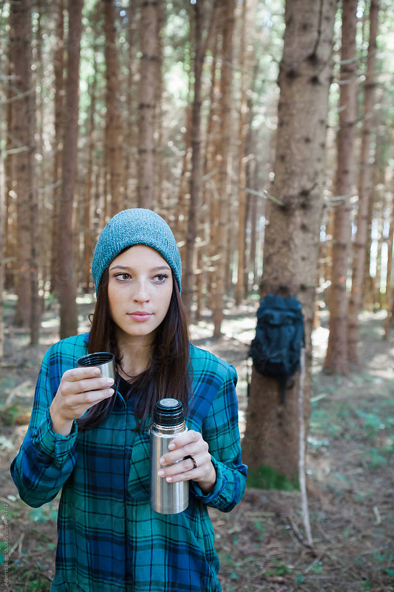 Woman Drinking Hot Tea In The Woods