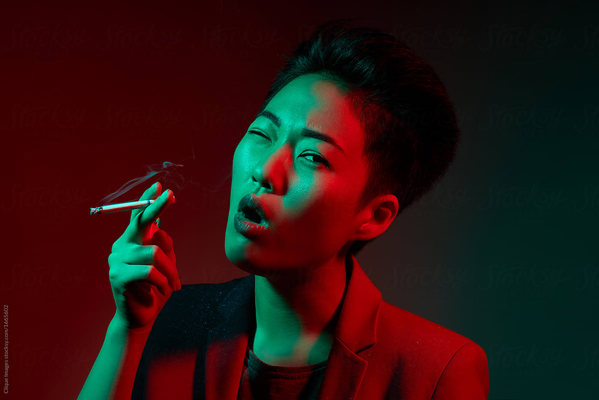 Smoking woman in neon illumination