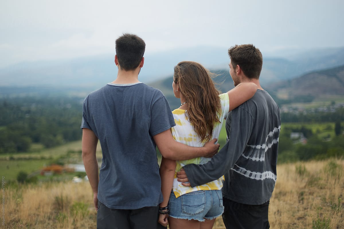 Back view of three teenagers watching the landscape