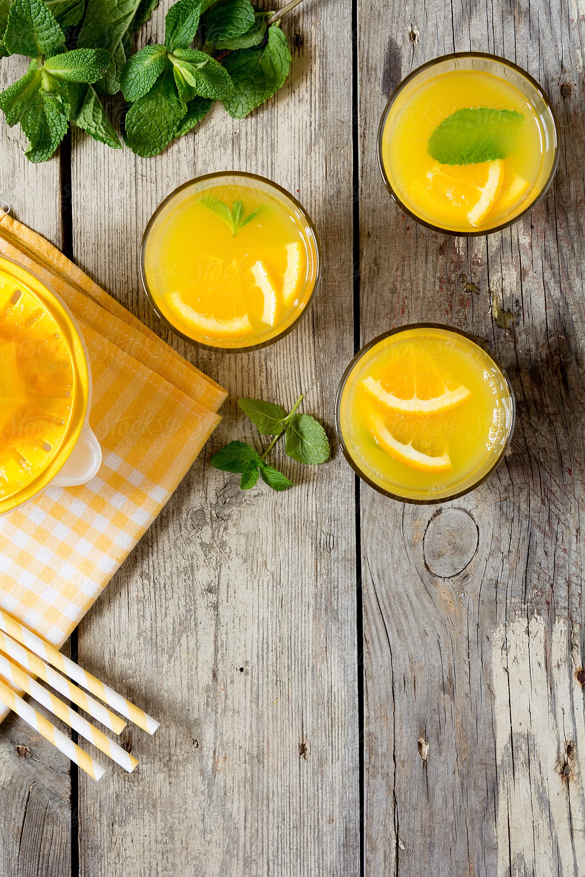 Drinks: orange juices, mint leaves, straws and citrus juicer from above