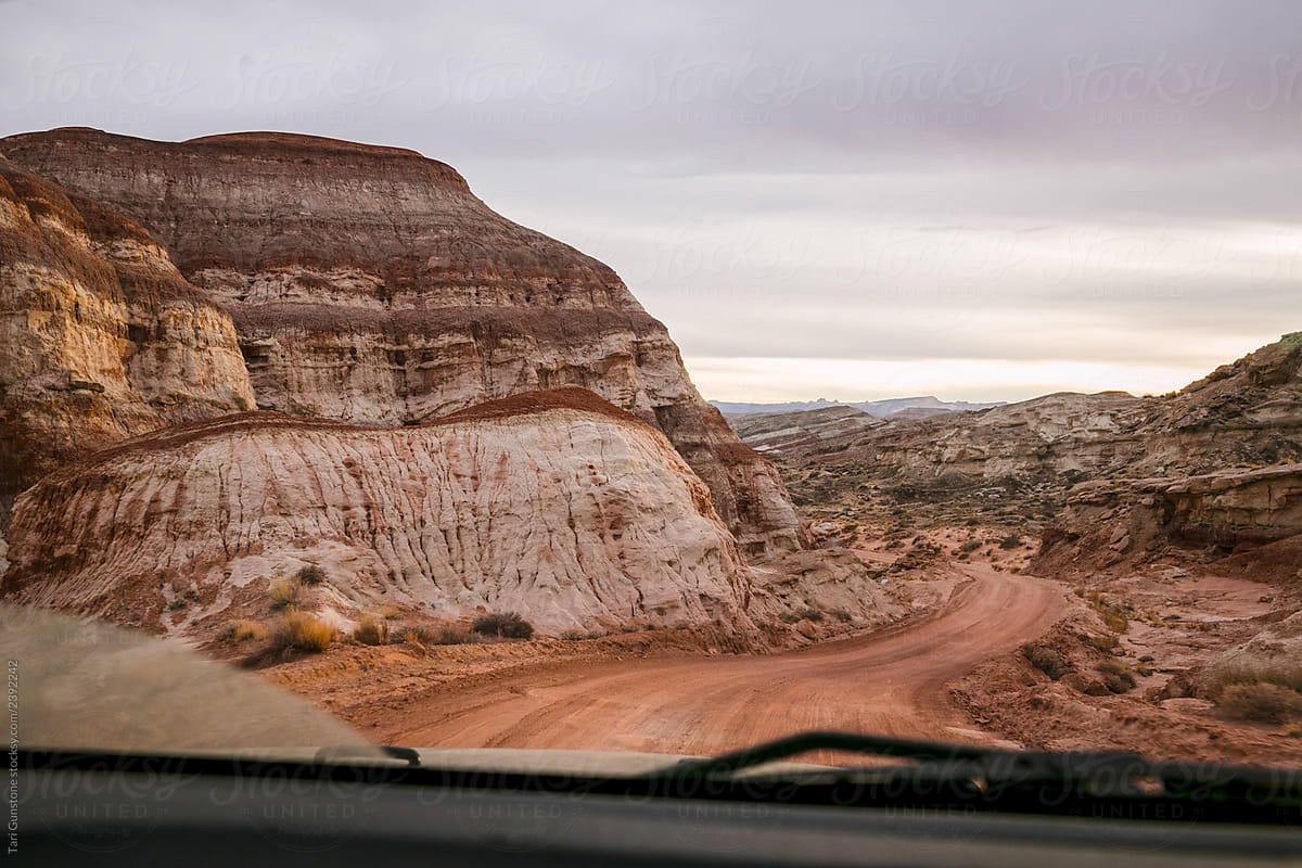 Colorful geological formations through car windshield