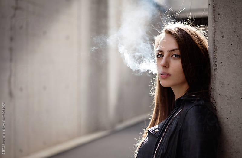 Portrait of a beautiful woman smoking outdoor