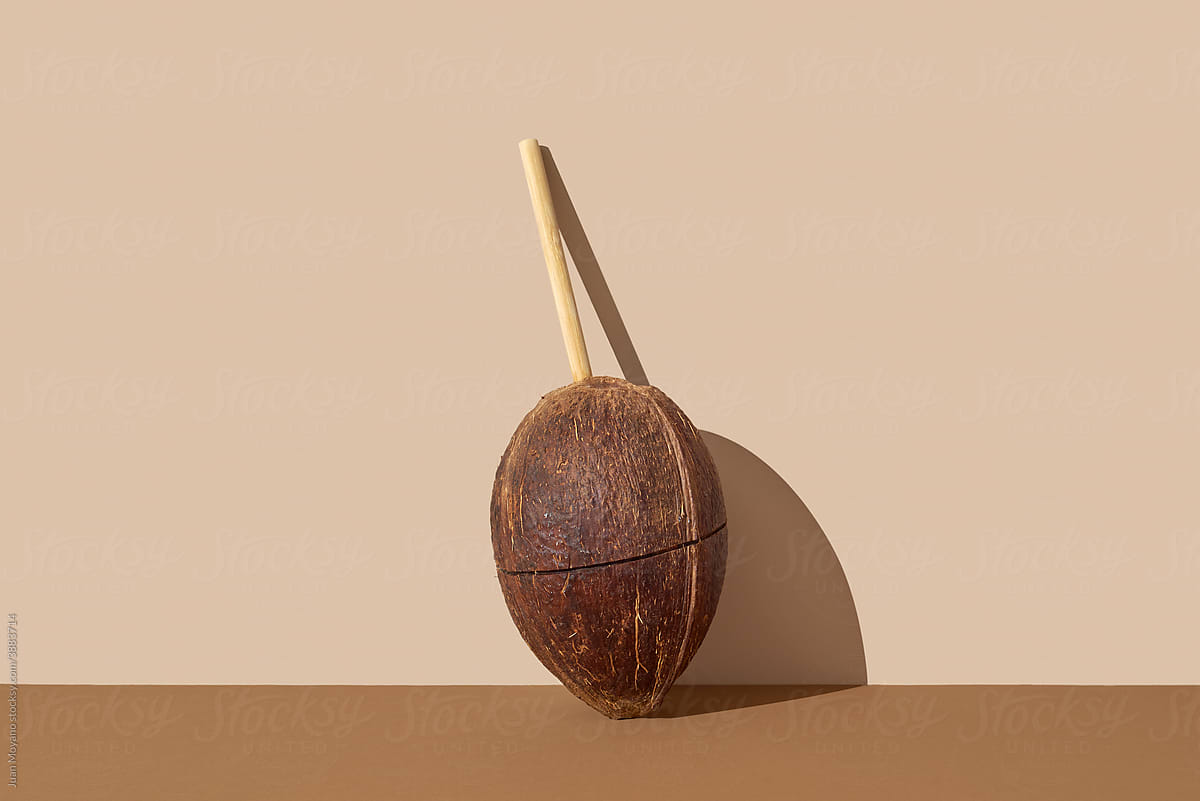 coconut with a natural drinking straw