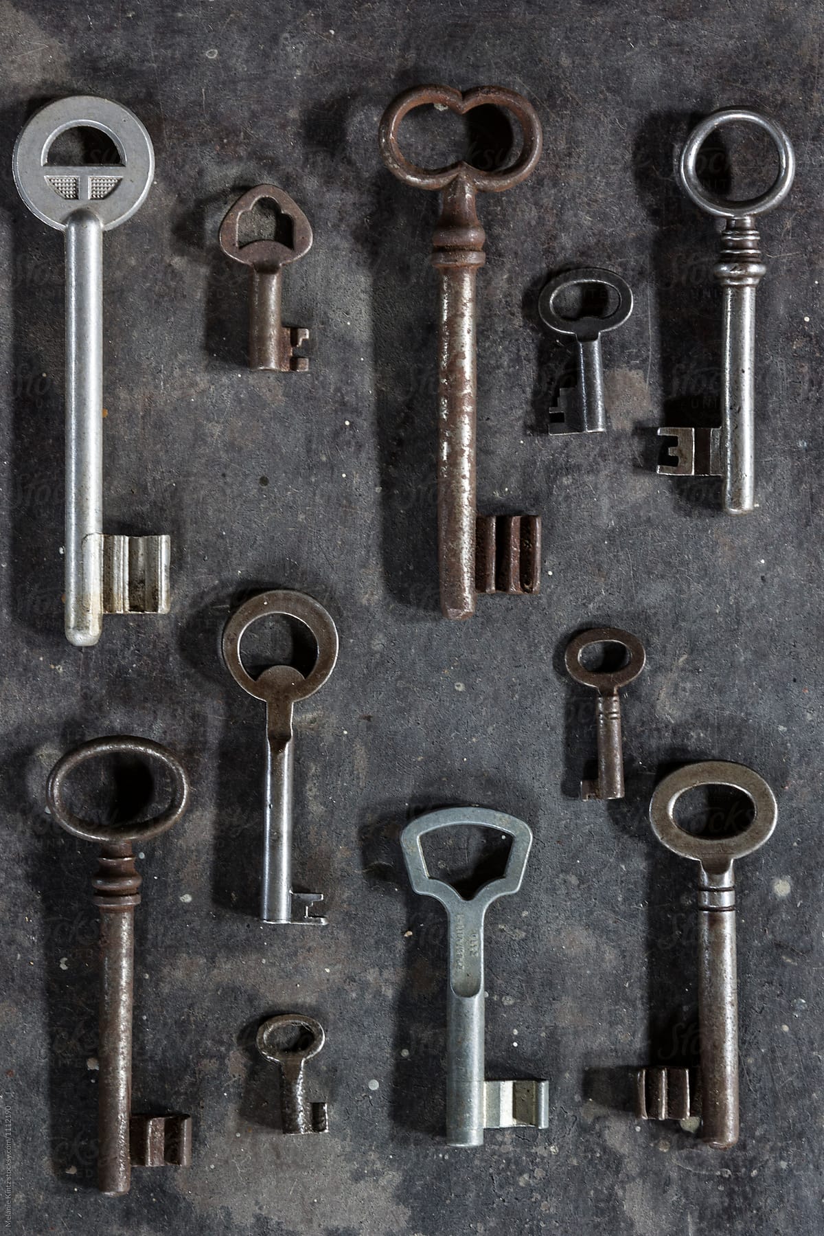 Many old keys on dark metal background