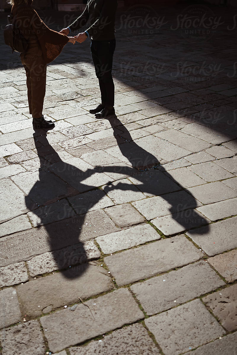 Shadow of an anonymous couple holding hands