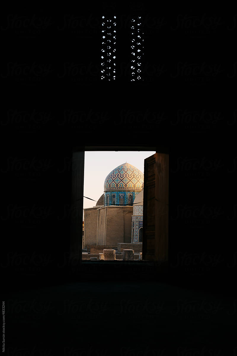 Open door in the dark room leading to the mosque, Samarkand