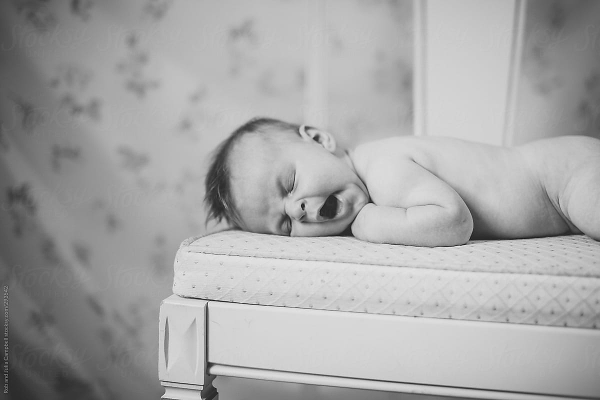 Creative portrait of baby girl lying on vintage chair