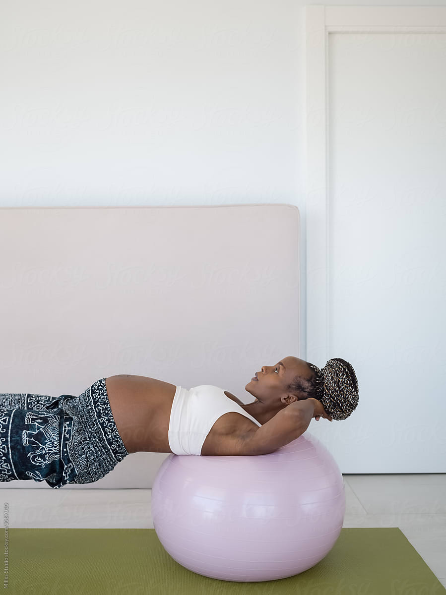 Pregnant woman training on fitness ball