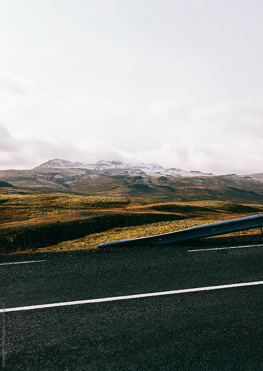 Driving Iceland - Black Tarmac Road Through Colorful Landscape