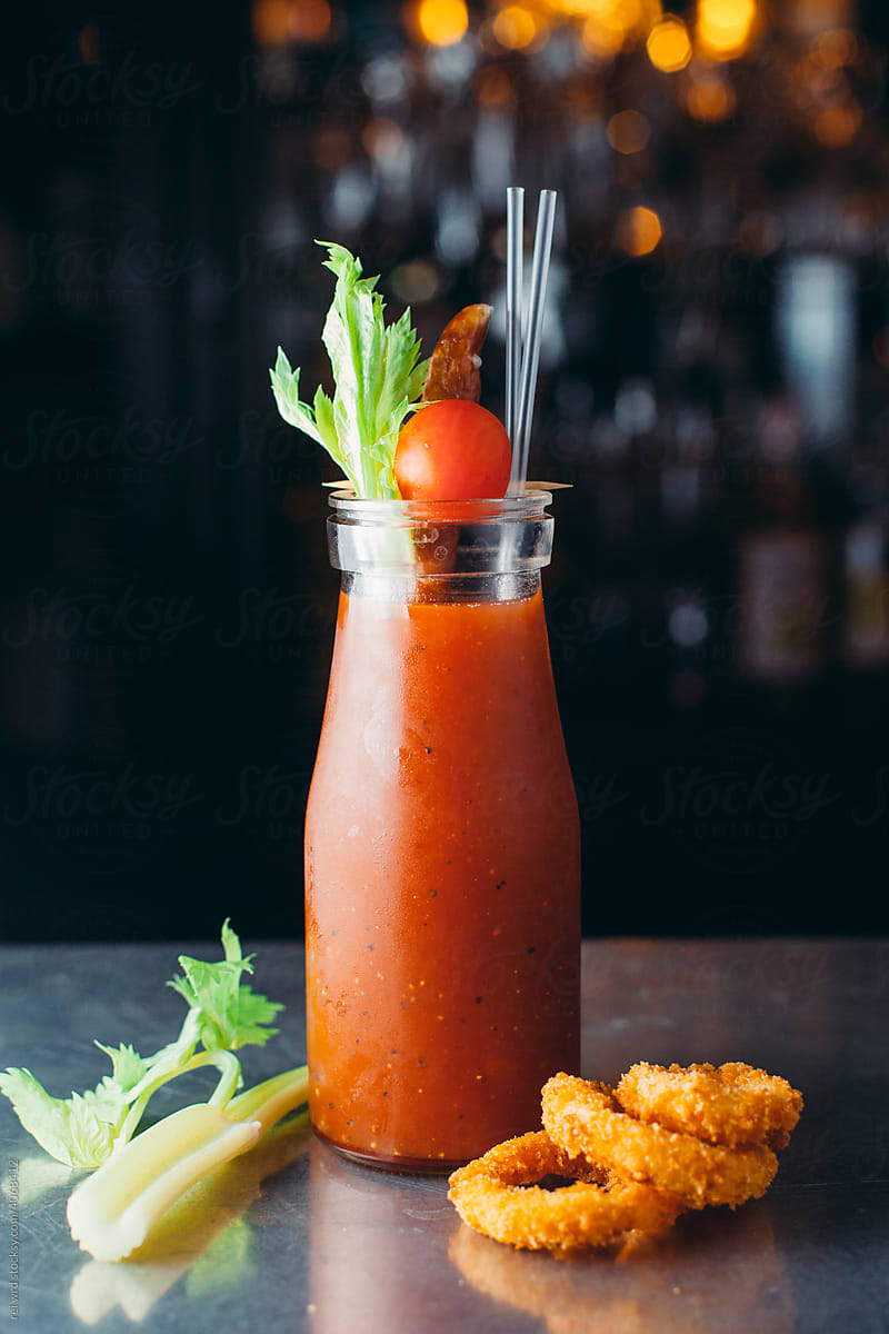 bloody Mary coctail with tomato and celery on a bar counter
