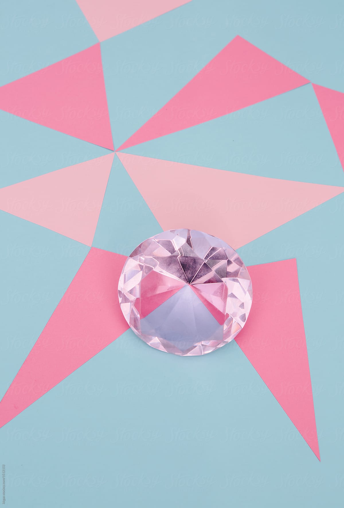 Large pink diamond on an abstract pink and blue background