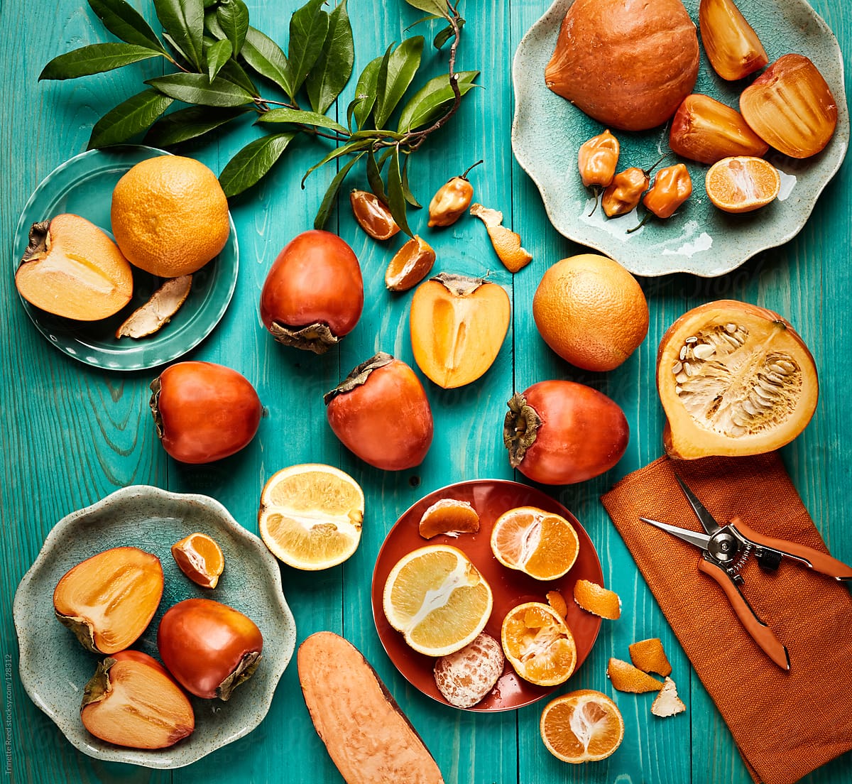 Still life of various orange colored fruits and vegetables