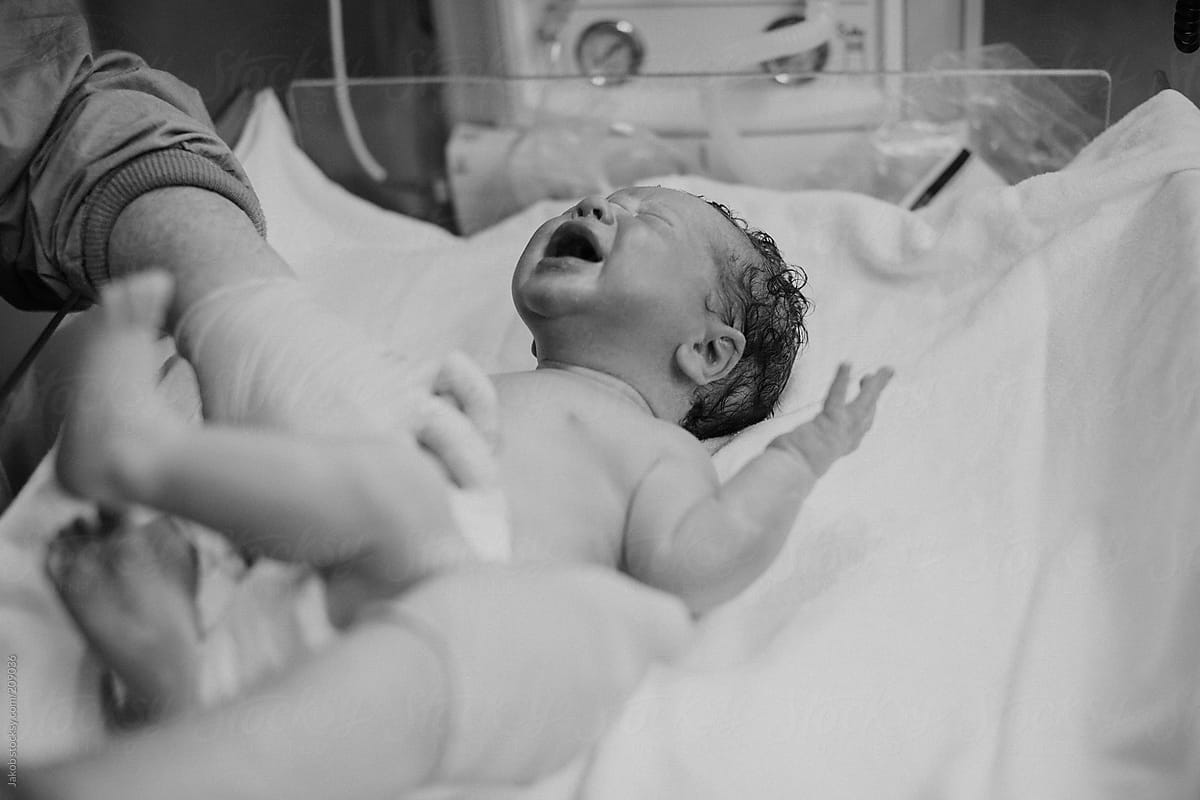 Newborn boy being washed at hospital