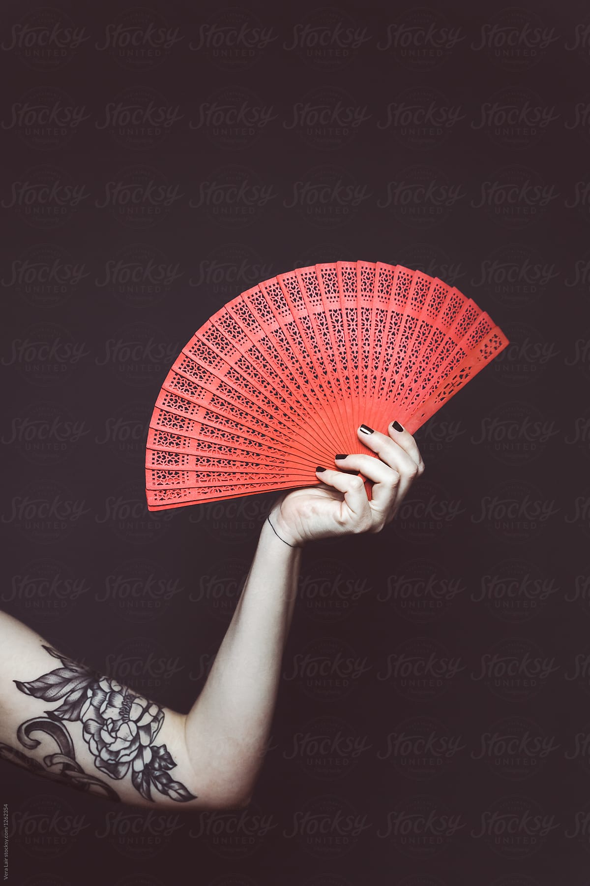 Woman holding a red fan