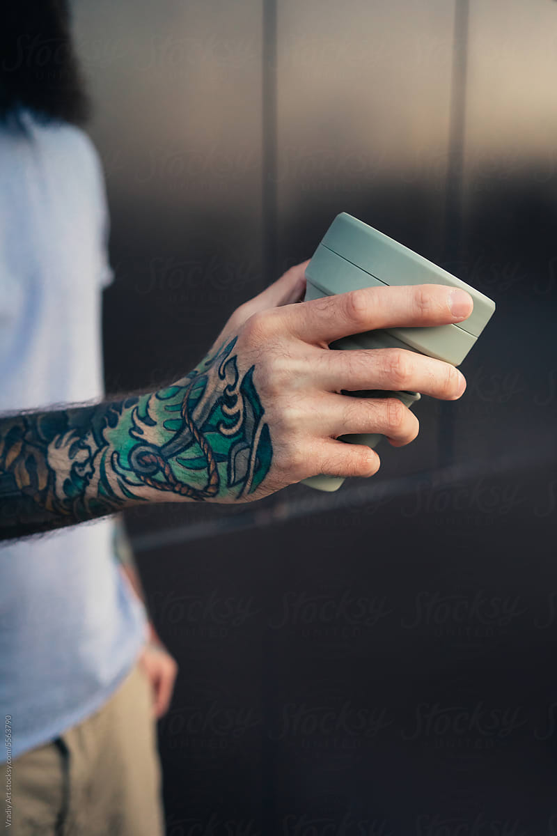 Reusable coffee cup in hand