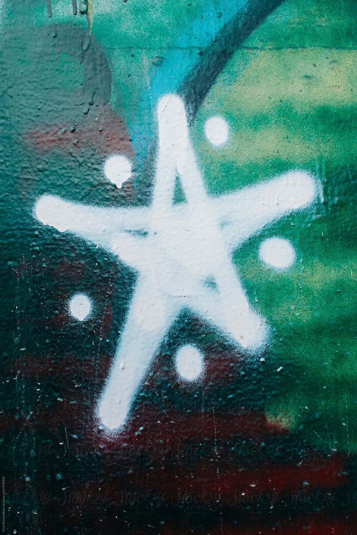 Star symbol spray painted on building wall, close up