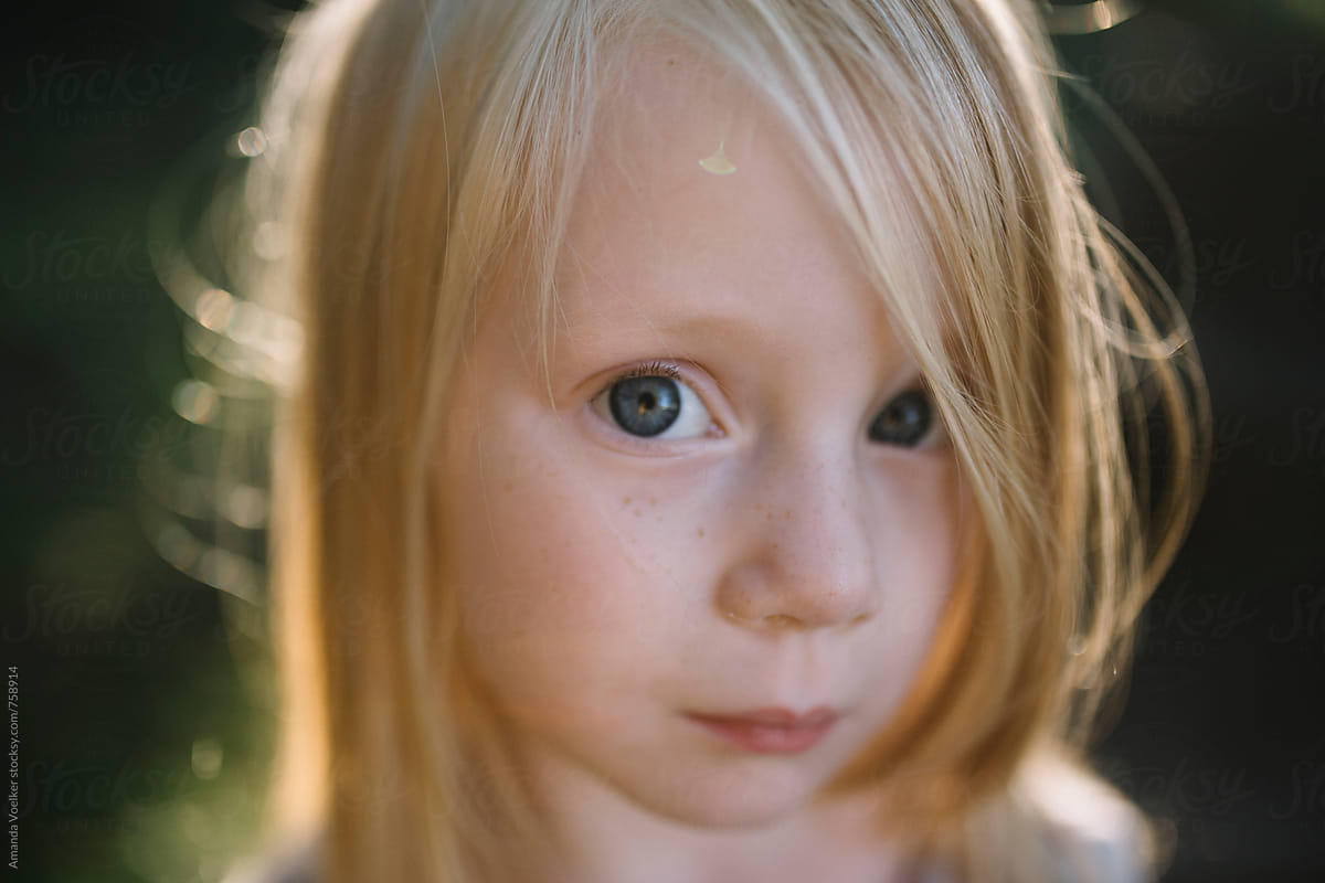 Innocent Close Up Portrait Of A Little Girl With Blonde Hair By
