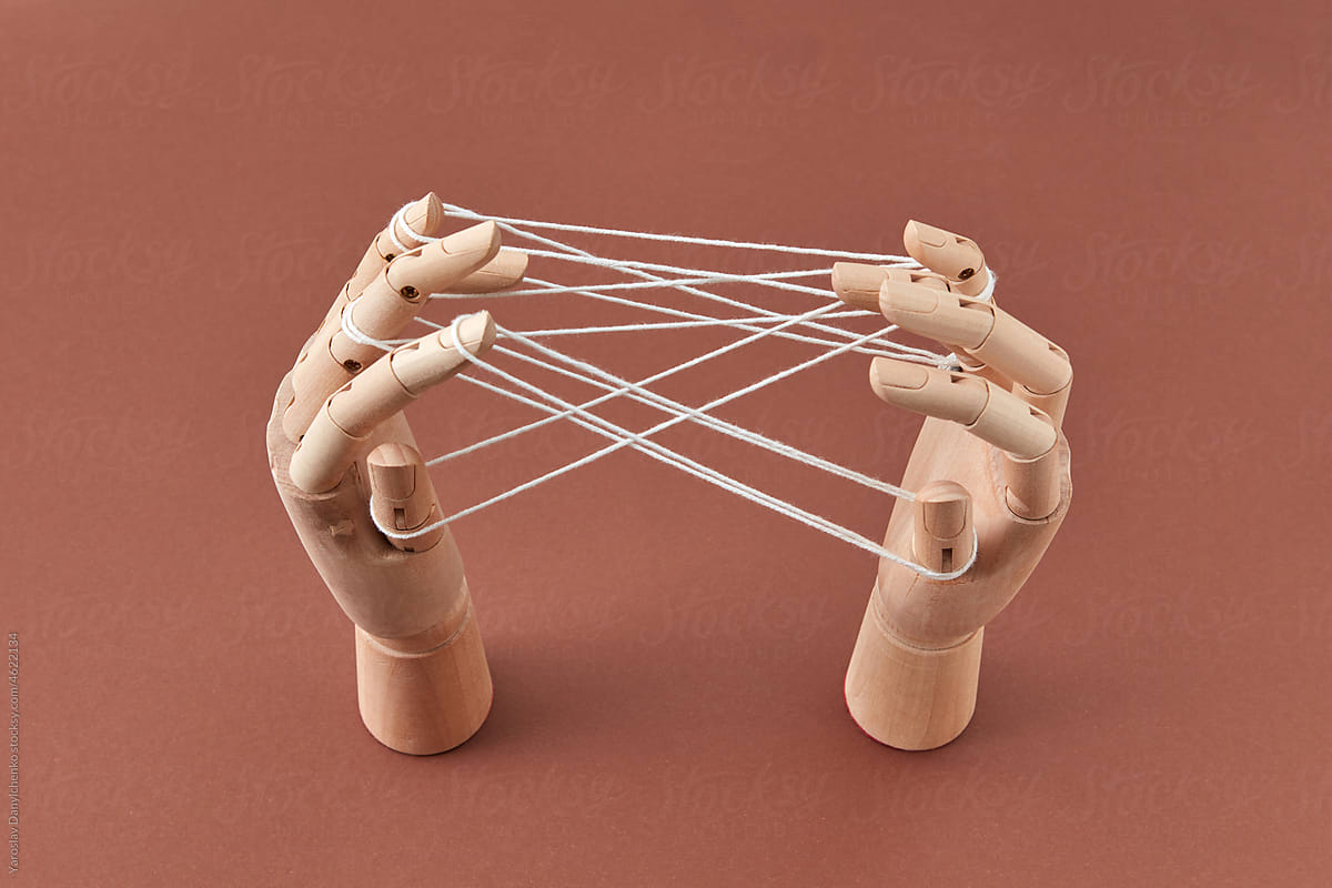 Figure from strings on wooden mannequin\'s hands.
