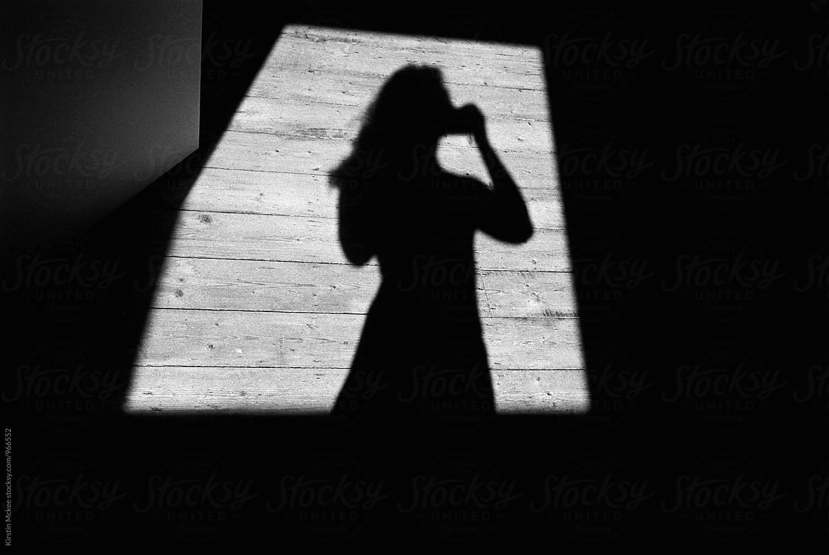 Shadow of woman in window of light