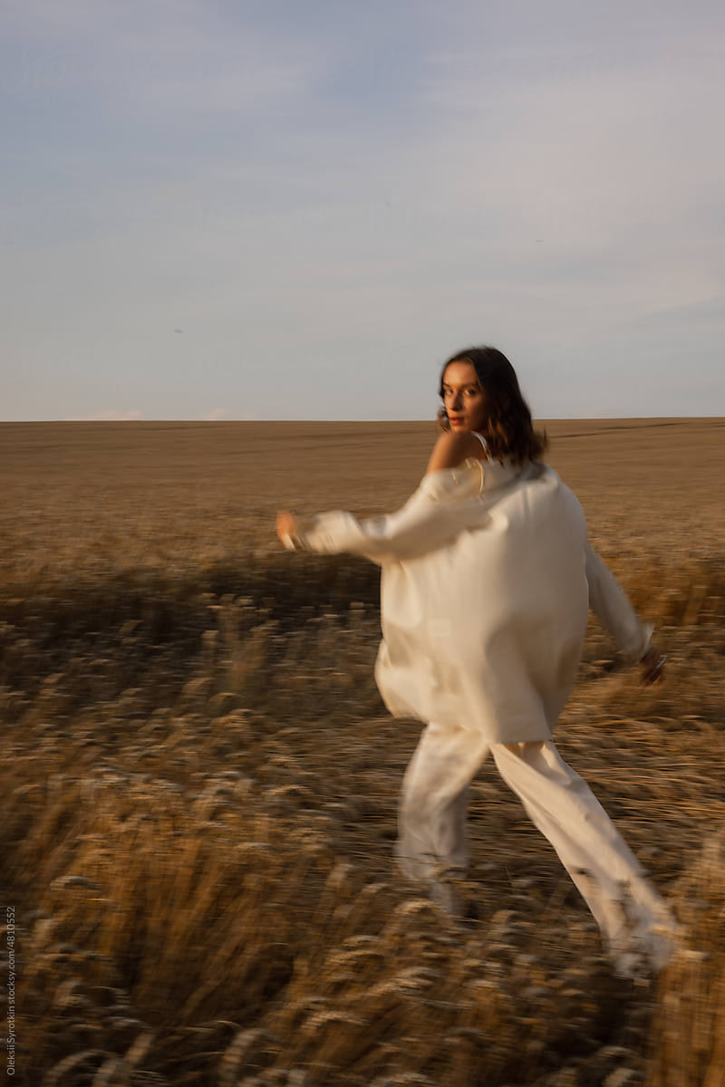 Woman moving in pyjama among steppe