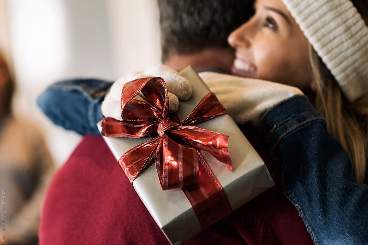Home: Girl Returning Home Holds Gift And Hugs Dad
