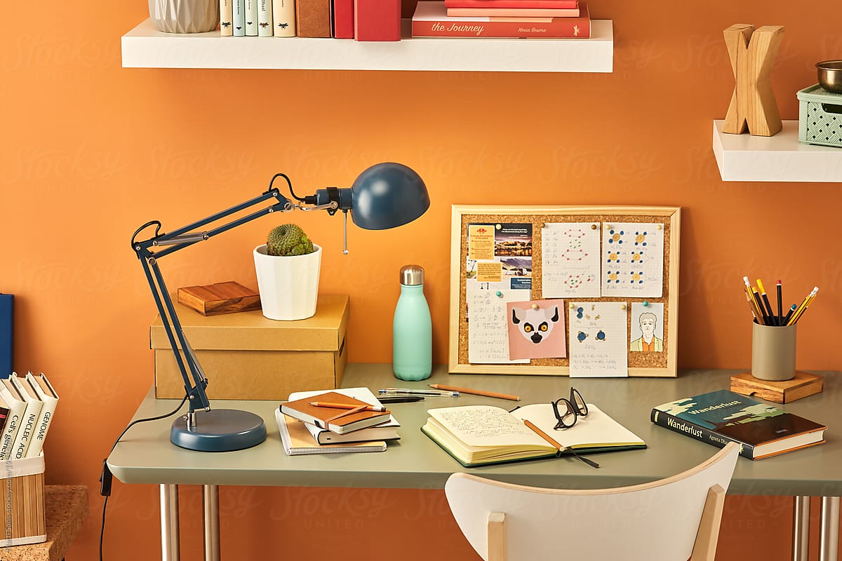 Student\'s workplace with books, pencils and pin board